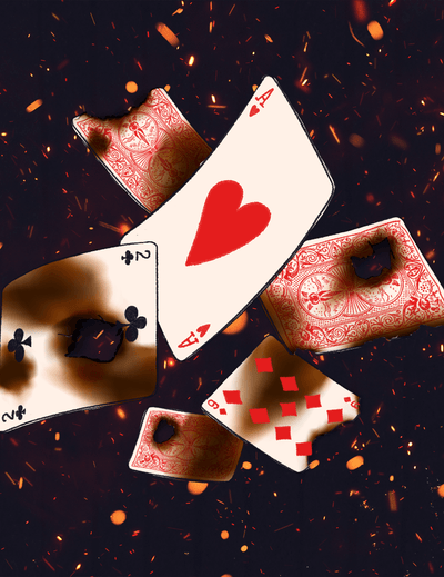 Burnt playing cards on a dark background